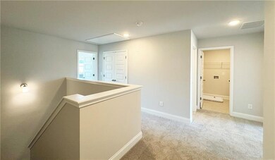 Corridor with attic access, light colored carpet, 
