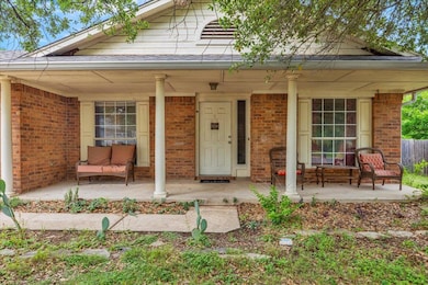 View of front facade with a porch and brick siding