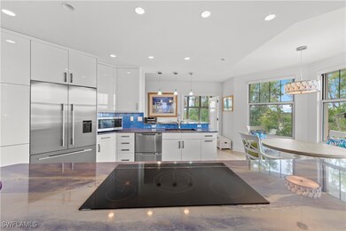 Kitchen featuring white cabinets, decorative backs