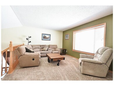 Upper level living room has tons of natural light 