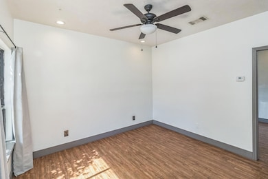 Spare room with wood finished floors, a ceiling f