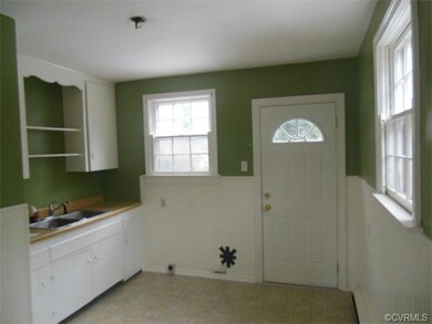 The kitchen is cozy and has access to the rear yard.
