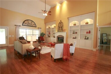 Expansive Great Room features Hardwood Floors, Natural Light, Fireplace, Shelving