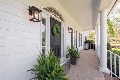 View of exterior entry with covered porch