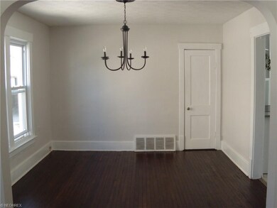 Dining room with refinished hardwood floor leads t