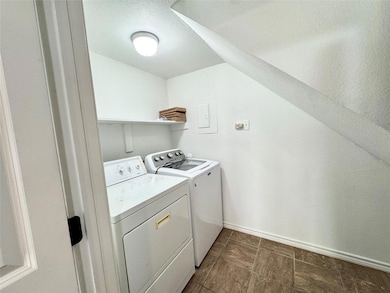 Laundry area featuring washer and dryer and a tex