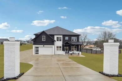View of front of property with driveway, a standin