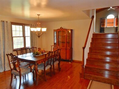 Dining room with hardwood flooring and steps to ad