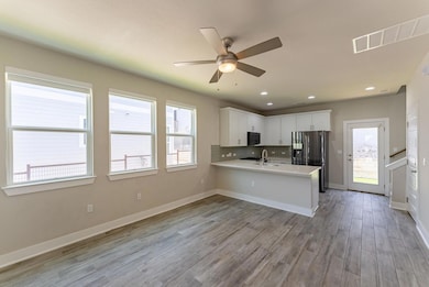 Kitchen featuring stainless steel fridge with ice