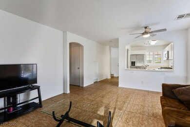 Living room with a ceiling fan, arched walkways, b