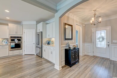 Entryway with an inviting chandelier, ornamental m