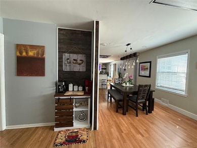 Dining space featuring baseboards and light wood-style floors