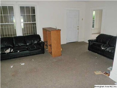 Living room area with front door in back ground.