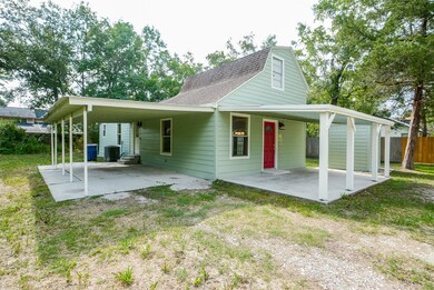 This view shows the oversized front porch PLUS covered Carport