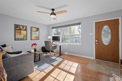 Office area with light wood-type flooring and a ceiling fan