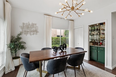 The dining room features a modern chandelier, a sl