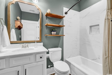 Full bath with toilet, vanity, and shower / bath combo
