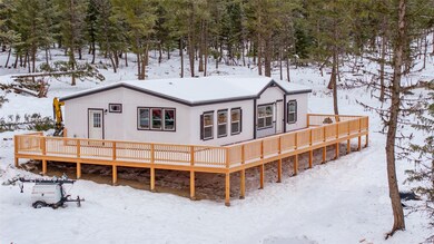 Snow covered property featuring a deck
