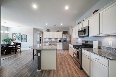 The kitchen features abundant storage space and lots of area to meal prep.