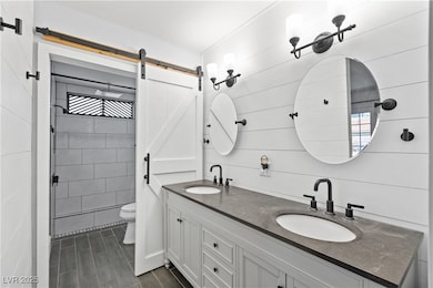 Bathroom featuring double vanity, toilet, plenty o