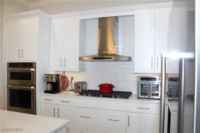 Kitchen with stainless steel appliances, white cab