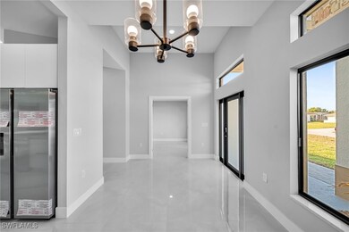Corridor with a notable chandelier and a high ceil