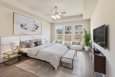 Come and unwind after a long day in this magnificent primary suite! This spacious room features gorgeous flooring, custom paint, high ceilings, dark stained ceiling fan with lighting and large windows.