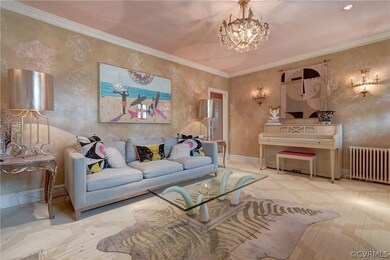 Living room featuring ornamental molding, radiator