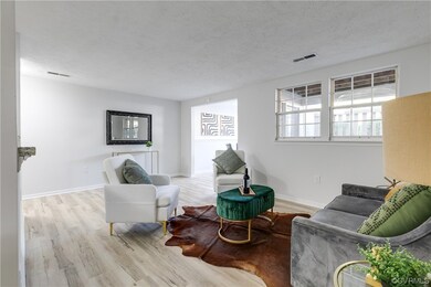 Living room with a textured ceiling and light hard