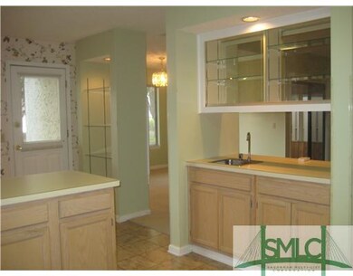 Kitchen. Lighted glass shelves between kitchen and