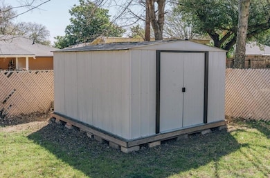 View of outdoor structure featuring a yard