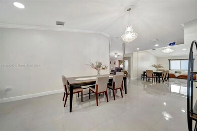 View from front door into dining room - Wall of mirrors brings in light with crystal chandelier