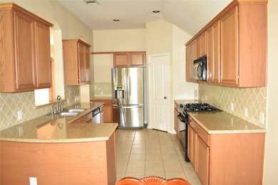 Kitchen with tile floor and granite countertop.
