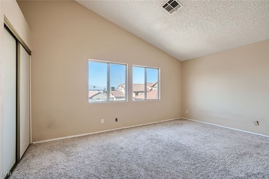 Unfurnished bedroom with carpet, a textured ceilin