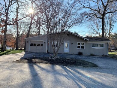 Front of house with circular driveway.