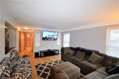 Spacious living room with hardwood floors and white trim as you walk in the front door!