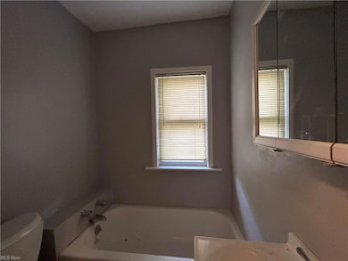 Bathroom with a bathing tub, mirror, and vanity