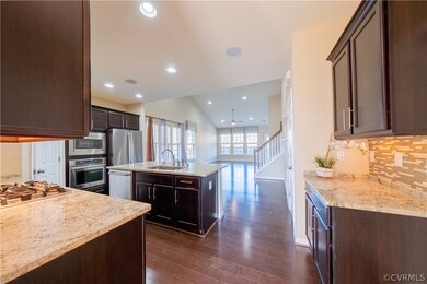 Kitchen featuring backsplash, sink, appliances wit