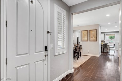 Entrance foyer featuring baseboards and dark wood-