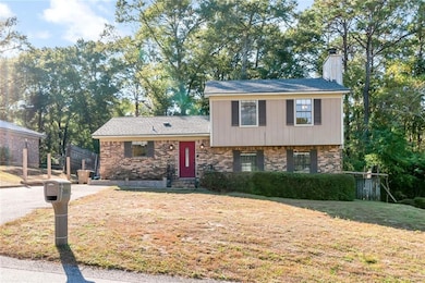 Split level home with a front lawn