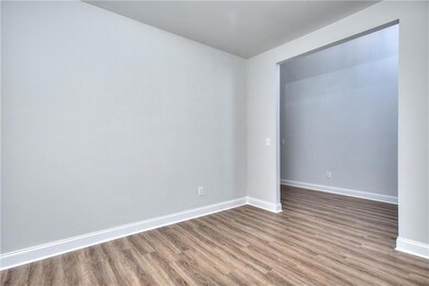 Unfurnished room with wood finished floors and bas