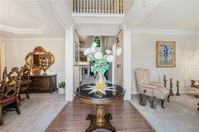 Entryway featuring crown molding and carpet