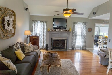 Living room w/beautiful hardwood flooring and fireplace