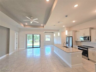 Kitchen with stainless steel appliances, open floo