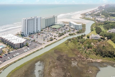 Aerial view of waterfront with a beach and apartment complex / building