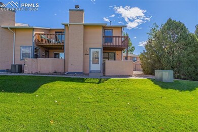Front of property featuring a lawn, and a balcony 