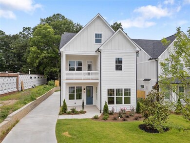 Modern inspired farmhouse featuring board and batten siding, a balcony, a shingled roof, and a front yard