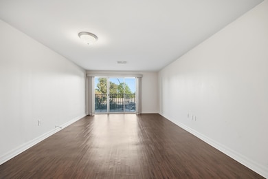 Living room with dark wood-style floors and baseboards