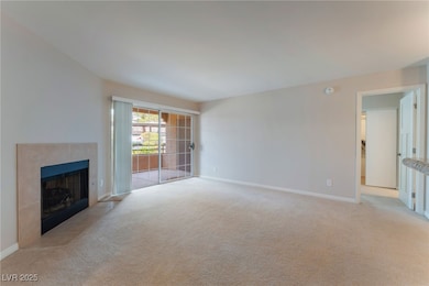 Unfurnished living room featuring light carpet, ba