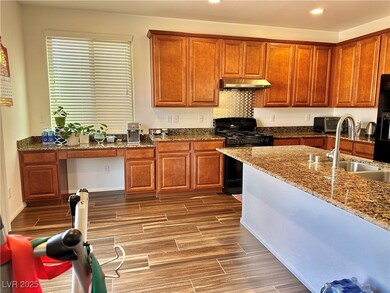 Kitchen with wood tiled floor, under cabinet range